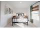 Bedroom with metal bed frame, wood nightstands, and green curtains at 1850 W Deaver Rd, Columbus, IN 47201