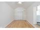 Bright bedroom featuring hardwood floors, a closet, and built-in bookshelves at 1901 E 68Th St, Indianapolis, IN 46220