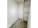 Small basement closet with shelving and carpeted floor at 1913 S Talbott Se St, Indianapolis, IN 46225