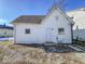 Rear view of a white house with gray roof and a small yard at 1913 S Talbott Se St, Indianapolis, IN 46225