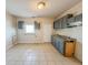 Galley kitchen with gray cabinets and tile floor at 1913 S Talbott Se St, Indianapolis, IN 46225