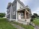 Side view of a duplex with stylish gray siding and a welcoming covered porch at 2033 Carrollton Ave, Indianapolis, IN 46202