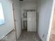 Unfinished hallway with closet and door at 2033 Carrollton Ave, Indianapolis, IN 46202
