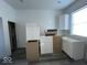 Unfinished kitchen with white cabinets and vinyl plank flooring at 2033 Carrollton Ave, Indianapolis, IN 46202