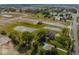 Aerial view of new community showcasing homes, ponds, green spaces, and surrounding mature trees at 2162 Warbler St, Danville, IN 46122