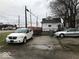 View of the home's backyard, with parking and a street in the background at 2165 S Meridian S St, Indianapolis, IN 46225