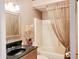 Bathroom with a black sink, gold mirror, and a shower tub combo at 21989 Schulley Rd, Cicero, IN 46034