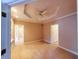 A neutral bedroom has a tray ceiling, ceiling fan, and beige carpet at 21989 Schulley Rd, Cicero, IN 46034