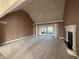 Spacious living room featuring vaulted ceiling, fireplace, and sliding doors to patio at 21989 Schulley Rd, Cicero, IN 46034