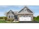 Gray exterior with stone accents, two-car garage, and landscaped yard at 2208 Walnut Frk Dr, Whitestown, IN 46075