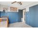 Charming Bedroom with blue walls, wood crib, and plenty of storage at 2210 Holden Dr, Anderson, IN 46012