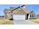 Two story brick home with white garage door and landscaping at 2230 Shadow Trace Way, Greenwood, IN 46143