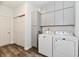 Well-equipped laundry room with gray cabinets and washer/dryer at 2230 Shadow Trace Way, Greenwood, IN 46143