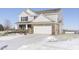 Two-story house with brick and siding, white garage door, and snow-covered lawn at 2248 Sante Fe Dr, Greenfield, IN 46140