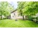 View of backyard including lush green grass and a small house at 361 S Spencer Ave, Indianapolis, IN 46219
