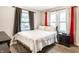 A bedroom with many windows, a bed and dark curtains at 361 S Spencer Ave, Indianapolis, IN 46219