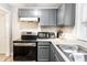 A kitchen featuring gray cabinets and stainless steel appliances at 361 S Spencer Ave, Indianapolis, IN 46219