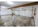 Large two-car garage with concrete floor and storage at 3819 S Village Dr, New Palestine, IN 46163