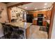 Kitchen with granite countertops, dark wood cabinets, and black appliances at 3819 S Village Dr, New Palestine, IN 46163