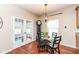 Cozy breakfast nook with glass-top table, black chairs, and French doors at 502 Elnora Ln, Westfield, IN 46074