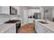 Modern kitchen with stainless steel appliances and white cabinets at 5246 Parkhurst Xing, McCordsville, IN 46055
