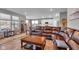 Open living room with a large sectional sofa and a view into the kitchen at 5246 Parkhurst Xing, McCordsville, IN 46055