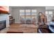 Bright living room with hardwood floors, fireplace, and view of backyard at 5246 Parkhurst Xing, McCordsville, IN 46055