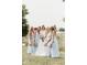 Bride and bridesmaids in light blue dresses pose for a photo on the grounds at 5465 S State Road 75, Jamestown, IN 46147