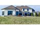 Rear view of a white brick house with a large backyard and patio area at 5465 S State Road 75, Jamestown, IN 46147