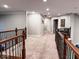 Bright hallway with carpeted floors and wooden railings at 5465 S State Road 75, Jamestown, IN 46147