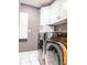 Laundry room featuring modern washer and dryer, and white cabinets at 5465 S State Road 75, Jamestown, IN 46147