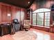 Home office with wood-paneled walls, large window, and comfortable armchair at 5465 S State Road 75, Jamestown, IN 46147