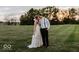 Bride and groom embracing in a field at sunset at 5465 S State Road 75, Jamestown, IN 46147
