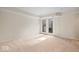 Spacious basement with neutral carpeting and patio access at 588 E Vermont St, Indianapolis, IN 46202