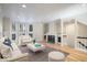 Sun-filled living room with hardwood floors, a fireplace, and staircase at 588 E Vermont St, Indianapolis, IN 46202