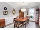 Spacious dining room with hardwood floors and elegant wood furniture at 7652 Winding Lake N Dr, Noblesville, IN 46062