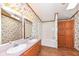 Bathroom with double vanity, tub and wood cabinets at 806 Indiana Ave, Alexandria, IN 46001