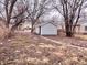 A view of the backyard with a detached shed featuring vinyl siding and a peaked roofline at 817 N Linwood Ave, Indianapolis, IN 46201