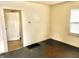 A view of the bedroom showcasing blank walls, and dark floors with a doorway to another room at 817 N Linwood Ave, Indianapolis, IN 46201