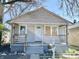 Modest home showcasing a porch and faded gray siding at 817 N Linwood Ave, Indianapolis, IN 46201