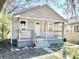 Modest home showcasing a porch and faded gray siding at 817 N Linwood Ave, Indianapolis, IN 46201