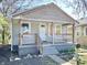 Modest home showcasing a porch and faded gray siding at 817 N Linwood Ave, Indianapolis, IN 46201