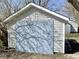 The garage features white siding and a large blue panel at 817 N Linwood Ave, Indianapolis, IN 46201