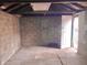 View of a garage space featuring an exterior door, small window, and block wall construction at 817 N Linwood Ave, Indianapolis, IN 46201