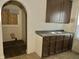 Outdated kitchen featuring wood cabinets and laminate countertops with a stainless steel sink at 817 N Linwood Ave, Indianapolis, IN 46201