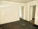A view of the living room showcasing blank walls, and dark floors with doorways to other rooms at 817 N Linwood Ave, Indianapolis, IN 46201