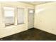 A view of the living room with hardwood floors, a bright window, and a plain white door at 817 N Linwood Ave, Indianapolis, IN 46201
