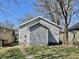 The side of the home features gray siding and a simple architectural design at 817 N Linwood Ave, Indianapolis, IN 46201