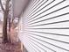 A close up of the side of the house with horizontal vinyl siding and a small window at 817 N Linwood Ave, Indianapolis, IN 46201