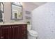 Cozy bathroom featuring a vanity with stylish mirror and storage cabinets, alongside a toilet with patterned shower curtain at 8198 Wade Hill Ct, Indianapolis, IN 46256
